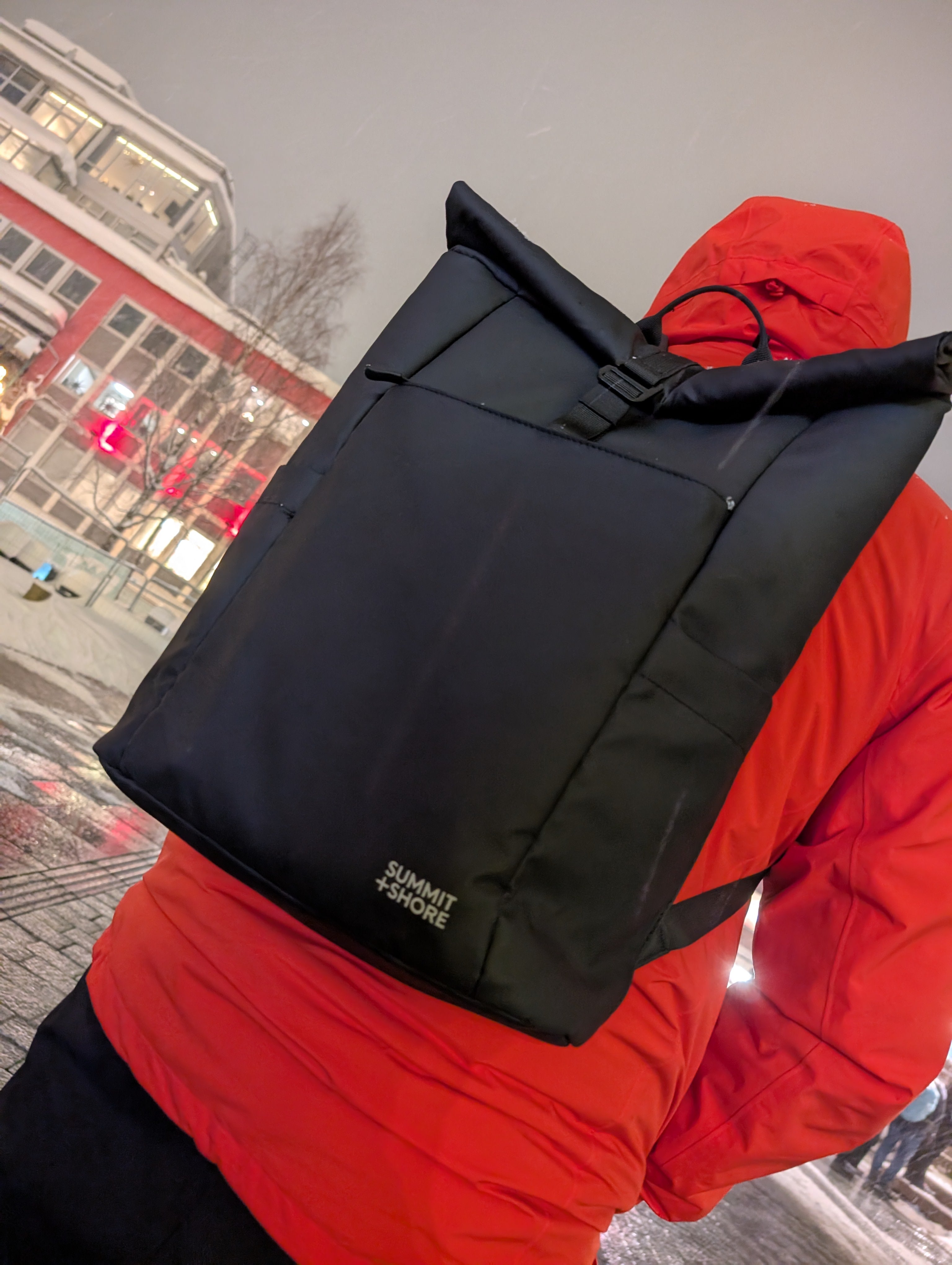 Summit+Shore The Daily 2.0 Backpack with Orange Jacket in A Winter City